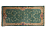 Vintage Nichols rug runner with jade green scrolling vinery and a sand Rococo-style border.