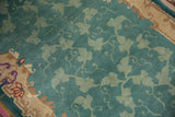 Detail of a vintage Nichols runner: soft jade green scrolling vinery with stylized Rococo border.