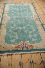 Rococo sand border with red accents, surrounding jade green cloudband vinery relief.