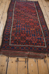 Vintage Belouch runner detail: madder root red diamond lattice, pomegranate main border, and kilim end.