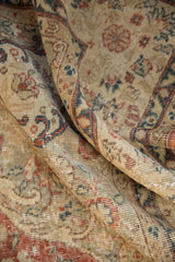 Vintage distressed Sparta carpet detail: mostly even pile wear, sand, rust, teal floral motifs.