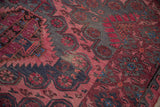 Abrashed fuchsia and charcoal geometric motifs on a distressed vintage Caucasian Soumac rug.