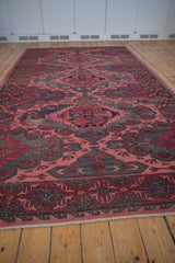 Faded vintage Caucasian Soumac rug, fuchsia and charcoal serrated geometric design.