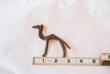 Vintage handmade bronze camel sculpture, showing detailed form and 3.5 inch length.