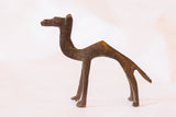 Vintage bronze camel sculpture in profile, showing its simple, stylized form and aged patina.