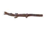 Vintage African bronze casting of a crocodile with a textured, patinated finish.