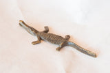 Detailed view of the African crocodile sculpture with its dark, aged bronze patina.