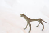 Side view of handmade African bronze cheetah sculpture with aged patina.