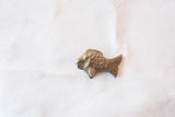 Hand-cast details on the scales and fins of a vintage bronze fish sculpture.