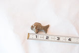 Handmade bronze fish collectible shown with a ruler to indicate its 2-inch size.