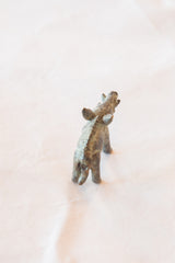The textured spine and hindquarters of a vintage African cast bronze boar figurine.