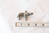 Vintage African bronze boar figurine shown next to a measuring tape to indicate its 2.5-inch scale.