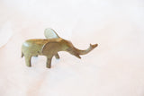 Vintage African bronze elephant sculpture with raised trunk and greenish-brown patina.
