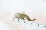 Patinaed vintage African bronze elephant casting, shown with a measuring tape for scale.