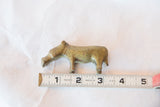 Vintage African bronze hippo sculpture measured with a tape showing its 3-inch length.