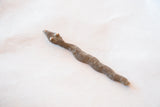 Close-up of the vintage African bronze snake with textured body and raised dots.
