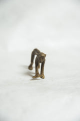 Front view of a vintage bronze monkey sculpture showing its expressive face and patina.