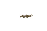 Vintage handmade African crocodile pendant with a textured, dark bronze patina.