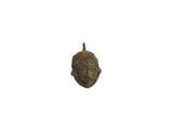 Vintage African small head pendant with a textured, dark bronze patina and stylized features.