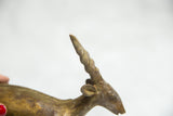 Bronze antelope sculpture close-up, showing detailed spiral horn and beautiful patina.