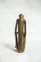 Back view of the vintage African monkey sculpture, highlighting its elongated torso and patina.