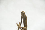 Vintage bronze monkey sculpture's head and chest detail with rich patina.