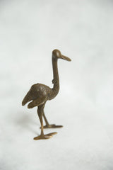 Textured bronze African ostrich sculpture with elongated neck and open wings.