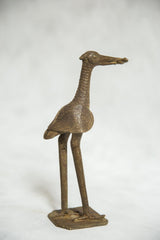 Vintage African bronze fishing bird sculpture in profile, highlighting its textured neck and spiral eye.