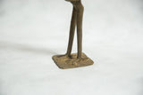 Lost wax cast bronze legs and square base of the African sculpture.