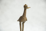 Textured body and scaled neck of the vintage African bronze bird sculpture.