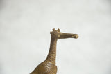 Patinaed African bronze fishing bird head, showing textured neck, beak, and twin horns.