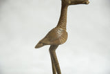 Intricate details of vintage African bronze fishing bird's textured neck and wing.