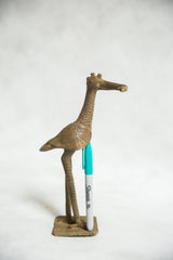 Vintage African bronze fishing bird sculpture with Sharpie marker showing scale.