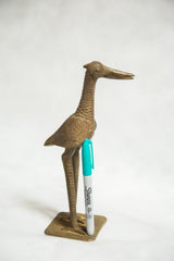 Vintage African bronze fishing bird sculpture, textured side view with turquoise Sharpie.