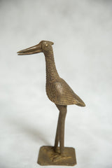 Textured bronze African fishing bird sculpture standing on a solid rectangular base.