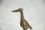 Vintage African bronze fishing bird sculpture with textured neck and spiral eye.