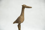Vintage African bronze fishing bird sculpture, detailed textured neck and head.