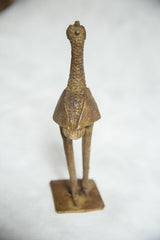 A tall African bronze bird sculpture with a textured neck, crested head, and stylized body.
