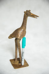 Vintage African bronze bird sculpture shown next to a marker to demonstrate its scale.