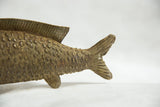 Detail of the cast bronze fish sculpture showing its textured scales and fins.