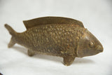 Angled profile of a vintage African bronze fish showing its detailed, textured scales.