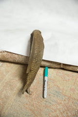Full length of the bronze bass fish sculpture viewed from above for scale.