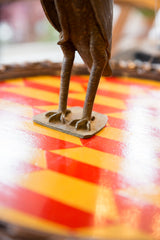 Vintage African bronze owl sculpture showing detailed casting of its feet and base.