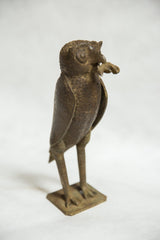 Vintage African bronze owl sculpture, angled view, showing rodent and detailed form.