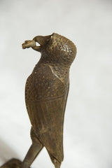 Vintage African bronze owl sculpture with intricate texture and rodent.