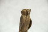 Detailed texture and intricate facial features of a vintage African bronze owl sculpture.