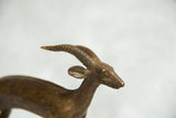 Vintage African bronze antelope sculpture's head with textured spiral horns.