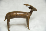 African bronze antelope sculpture with spiral horns and aged patina.