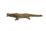 Vintage African bronze sculpture of a crocodile holding a fish, with detailed, textured scales.