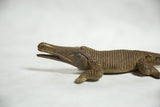 Intricate details on the vintage African bronze crocodile's head, eye, and scales.